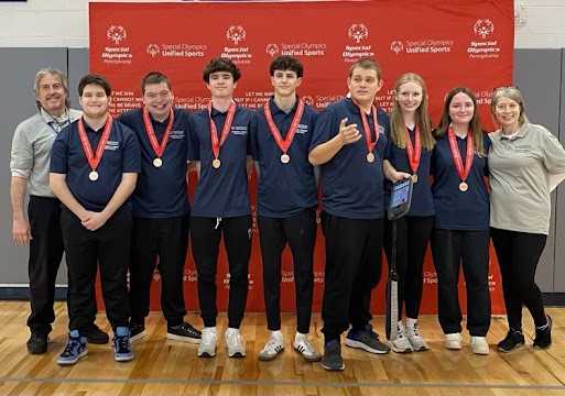 Unified Bocce team members pose at Regionals with their medals.