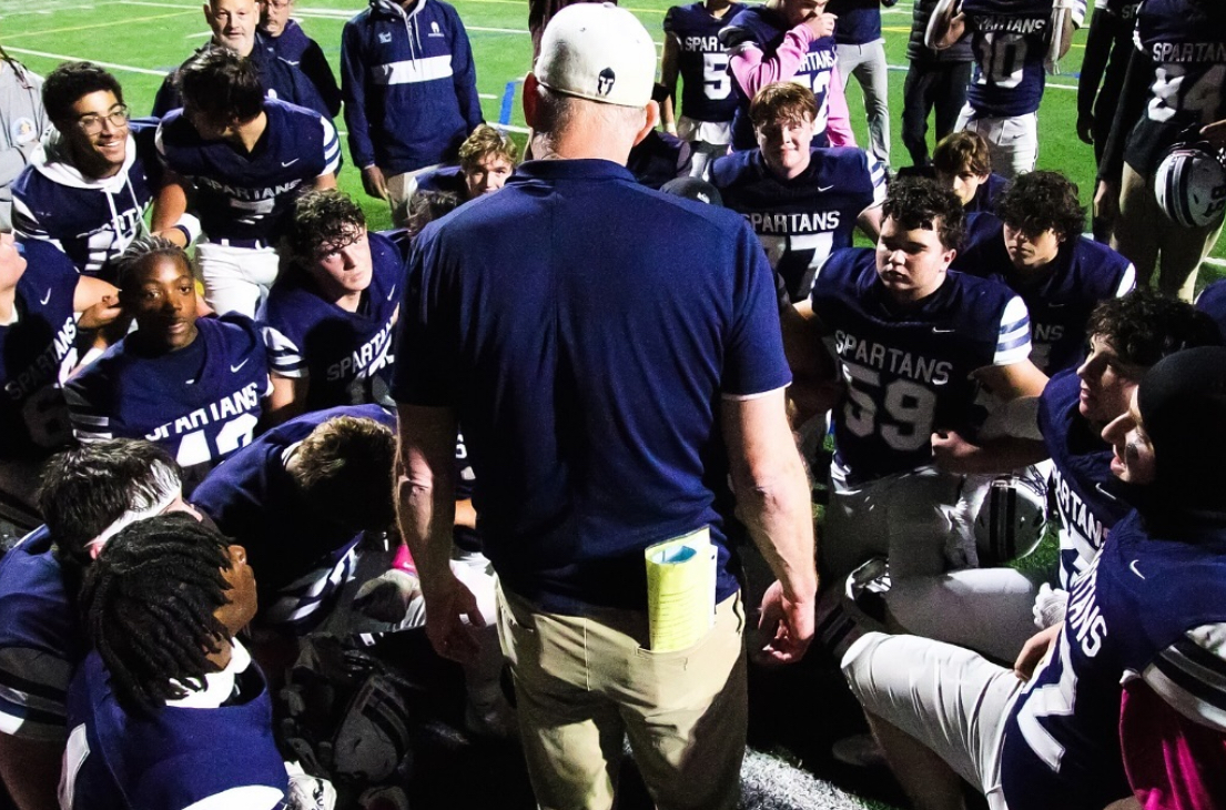 Coach Shelly and the Spartans during a timeout.