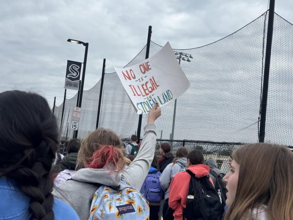 Student with sign at walkout